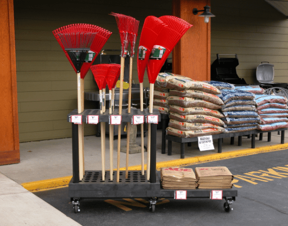 wheeled card holding yard rakes and gardening supplies