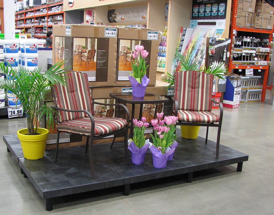 two chairs and flowers set up on a plastic display