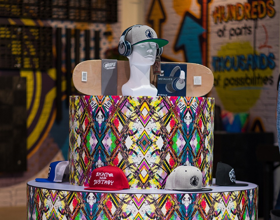 a plastic display stand with mannequin heads and fun wrapping colors