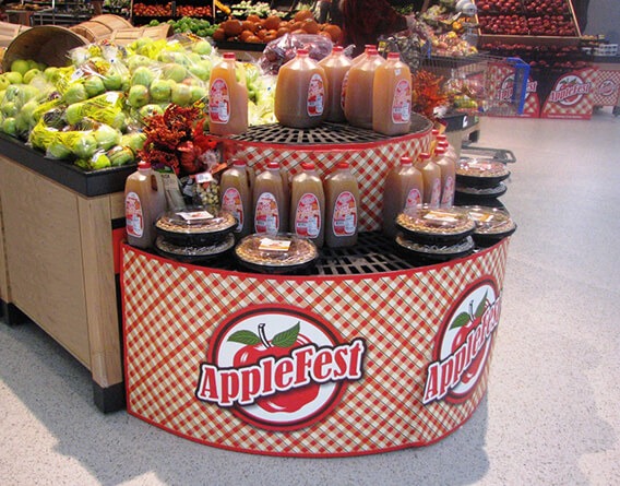 Applefest display with apple cider and pies in a grocery store