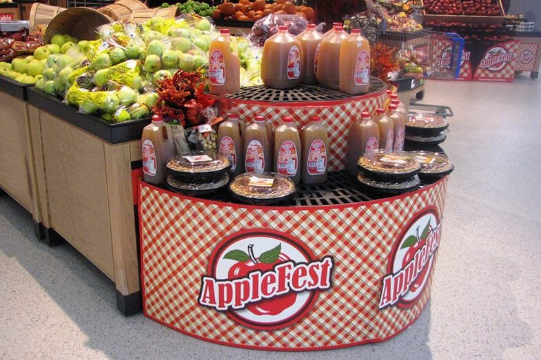 Applefest display with apple cider and pies in a grocery store