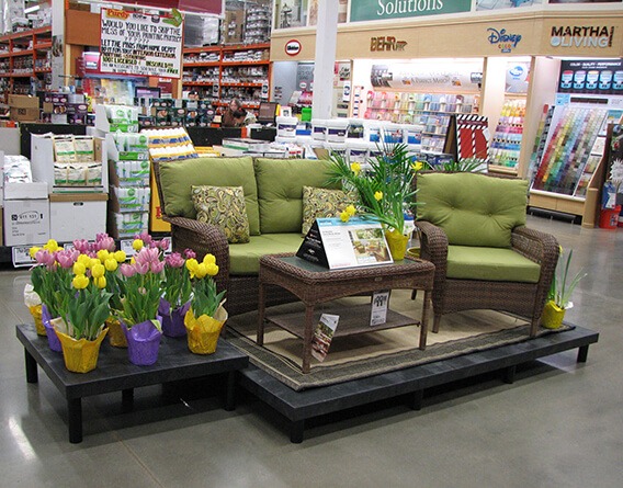 Display with outdoor furniture and plants