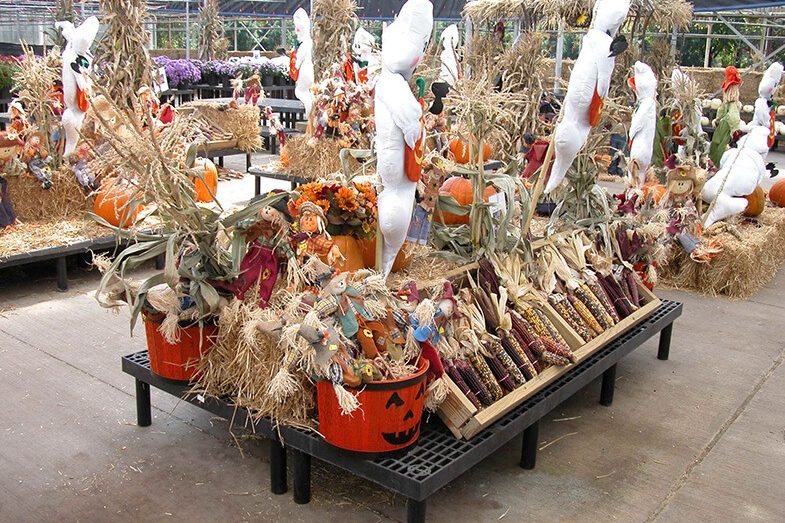 Fall seasonal display with maze, scarecrows and ghost decorations