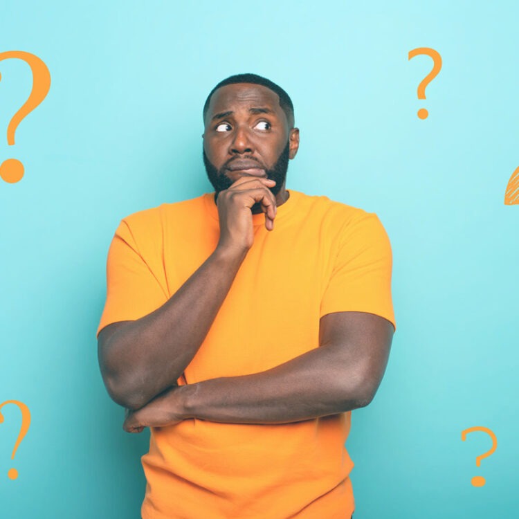 Man thinking in front of blue background with question marks around him